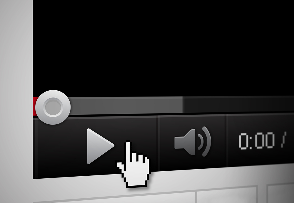 A mouse hovers a play icon in the corner of a screen as a video loads